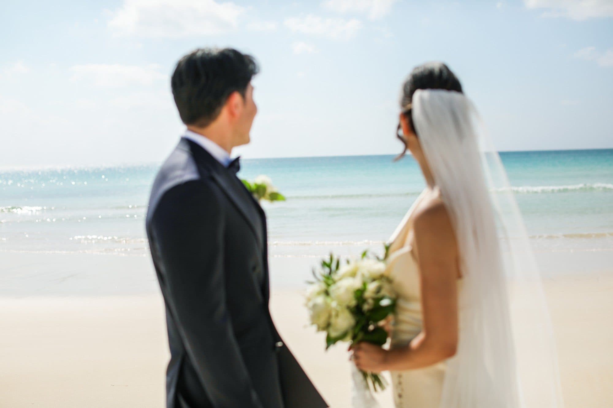 A couple looking out over the turquoise sea in Okinawa